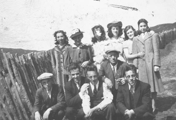 311: l-r kneeling, Cyril Carroll, Jim Spurvey, Pat Carroll, Mike Lambe, Mike Carroll, standing,  Anne Spurvey, Ellen (Norman) Carroll, Betty Carroll, Carmel Carroll, Sadie Norman,  Anne Lambe, at the Herring Cove. (1942) [courtesy of Betty (Carroll) Spurvey]  - Cyril, Pat, Mike, Betty &amp;amp; Carmel Carroll children of William Carroll &amp;amp; Ellen Norman;  Mike son of James Lambe &amp;amp; Anastasia Whiffin; Anne daughter of Michael Lambe &amp;amp; Johanna Best,  married Patrick Norman; Ellen daughter of Michael Norman &amp;amp; Mary Anne Mulrooney, married William  Carroll; Sadie daughter of Thomas Norman &amp;amp; Jane Traverse, married Leo Kerrivan; Jim Spurvey  married Betty Carroll; Anne Spurvey related to Jim